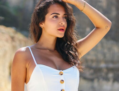 woman in white tank top holding her hair